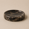 Marble tray with black and white pattern on a beige background