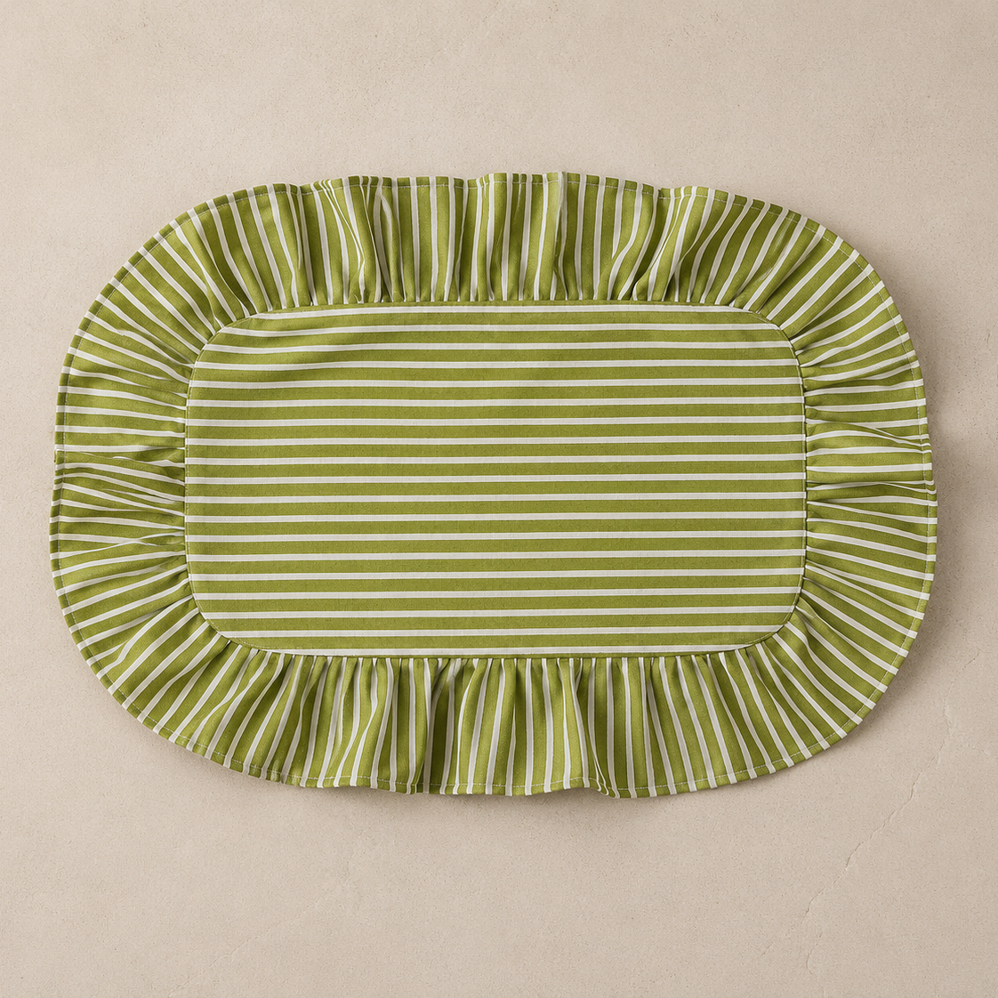 Green and white striped fabric placemat on a beige background